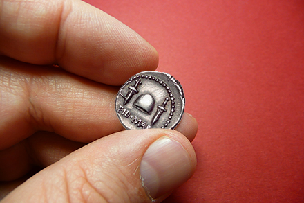 Holding ancient coin Holding ancient coin